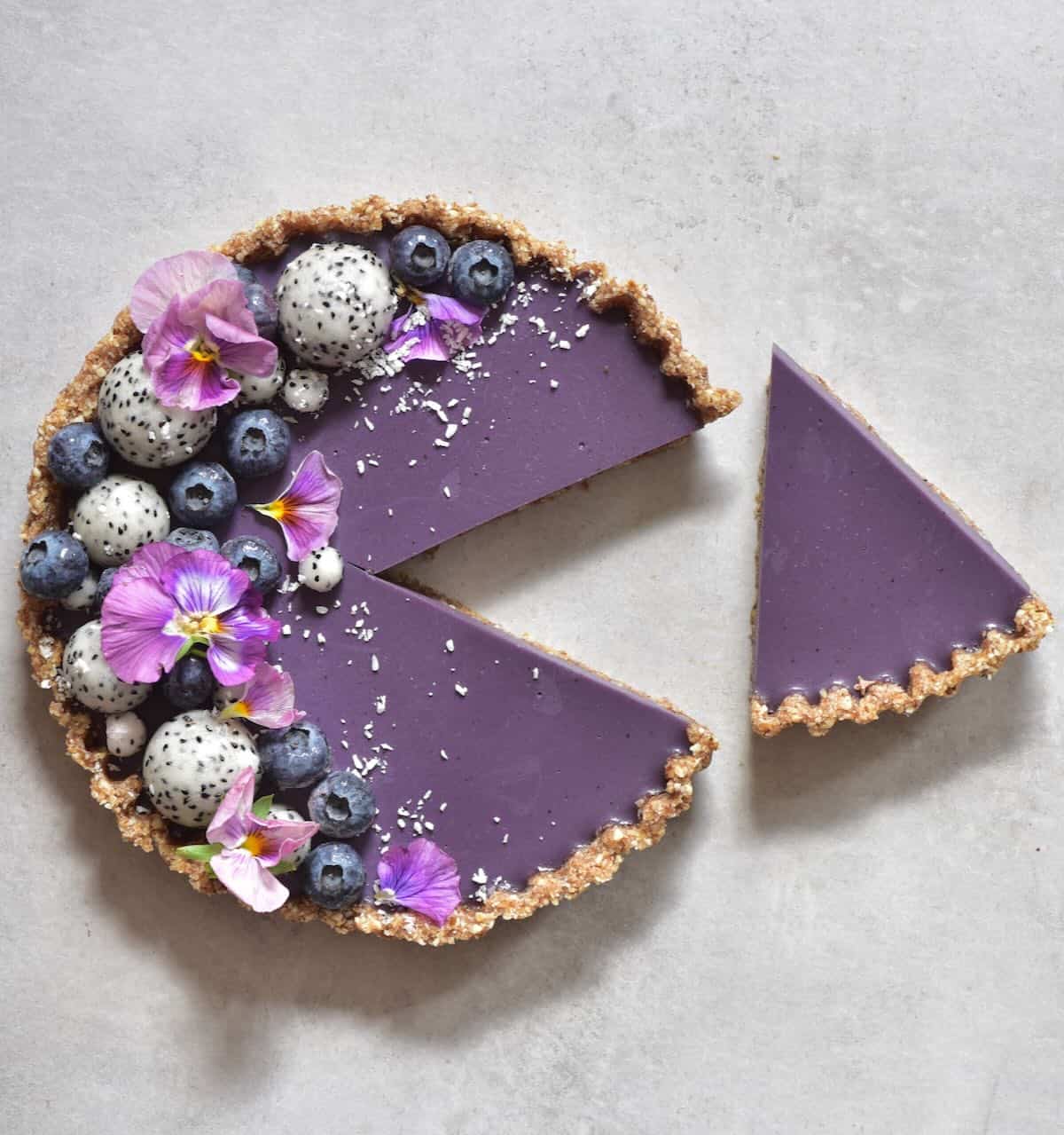 A no bake blueberry tart with a slice cut off
