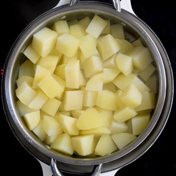 Boiled cubes of potatoes in a colander