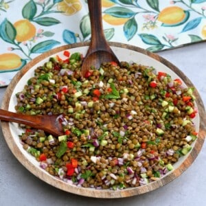 A serving dish with healthy lentil salad topped with mint leaves