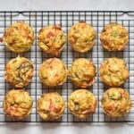 Twelve veggie muffins cooling on a wire rack - 14