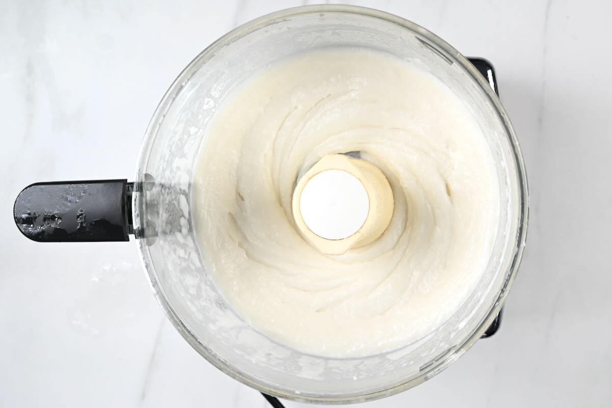 Fully emulsified garlic sauce in food processor.