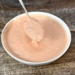 Homemade In-N-Out sauce in a small white bowl with a spoon dipped in it. - 5