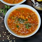 A serving of freshly made lentil soup topped with microgreens and black pepper. - 23