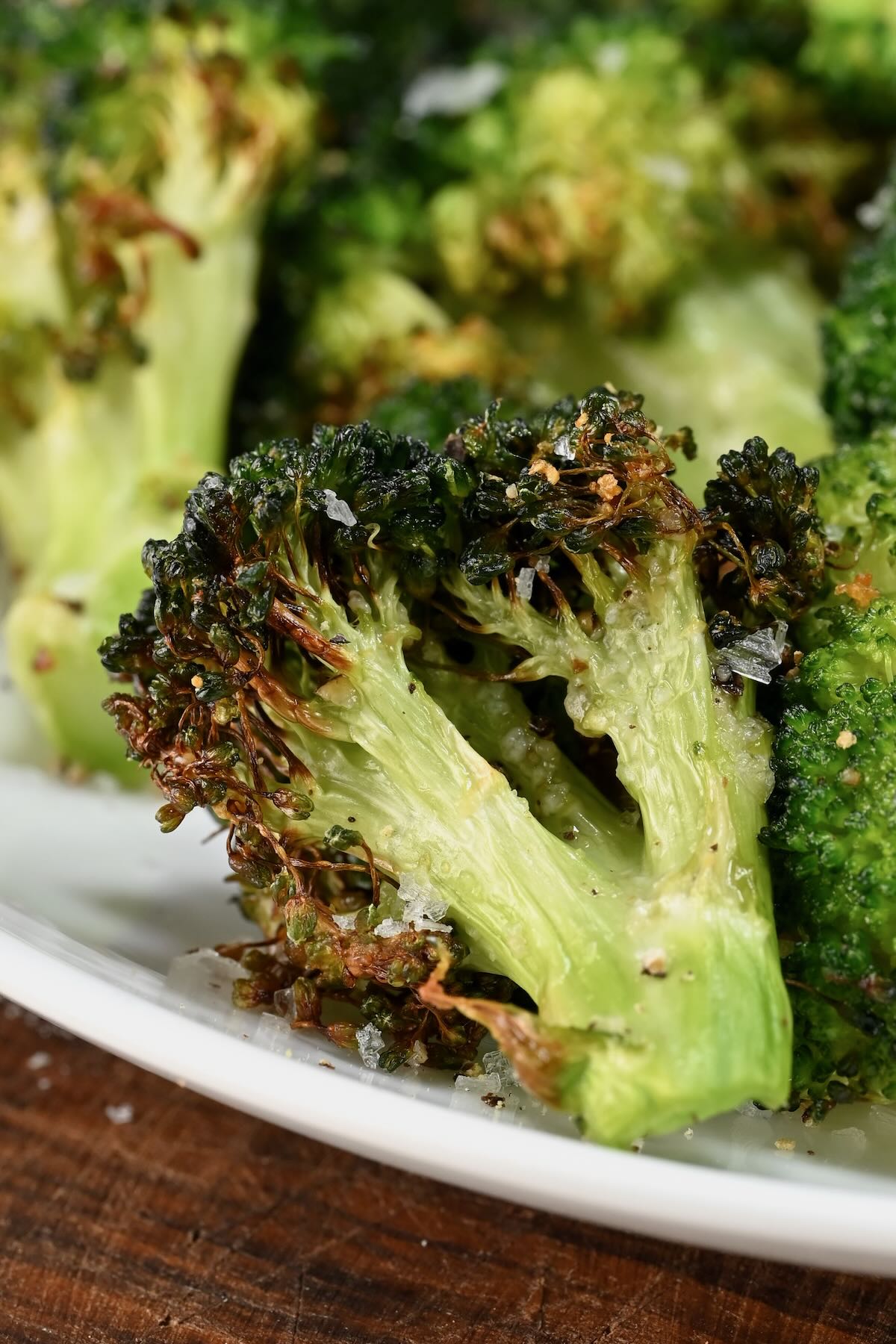 A close up of air fried broccoli florets.