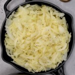 A large pan with boiled shredded cabbage with pepper sprinkled over it. - 14