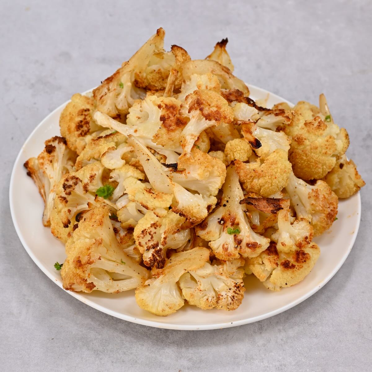 A large servinf of freshly roasted cauliflower florets. - 72
