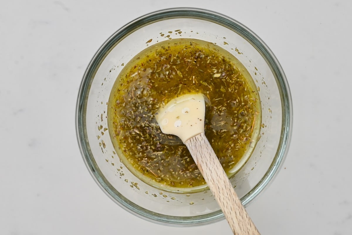 2 Chicken marinade ingredients in a glass bowl with a spatula, top view