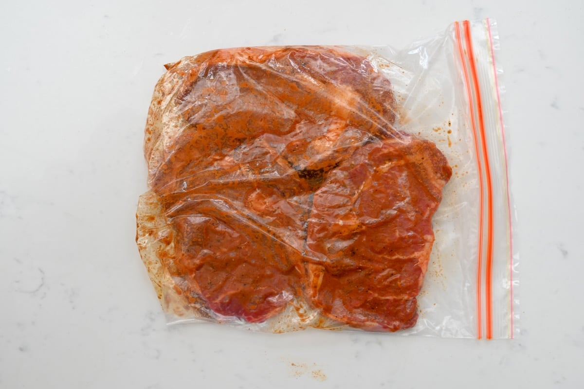 steak marinated inside a ziplog bag