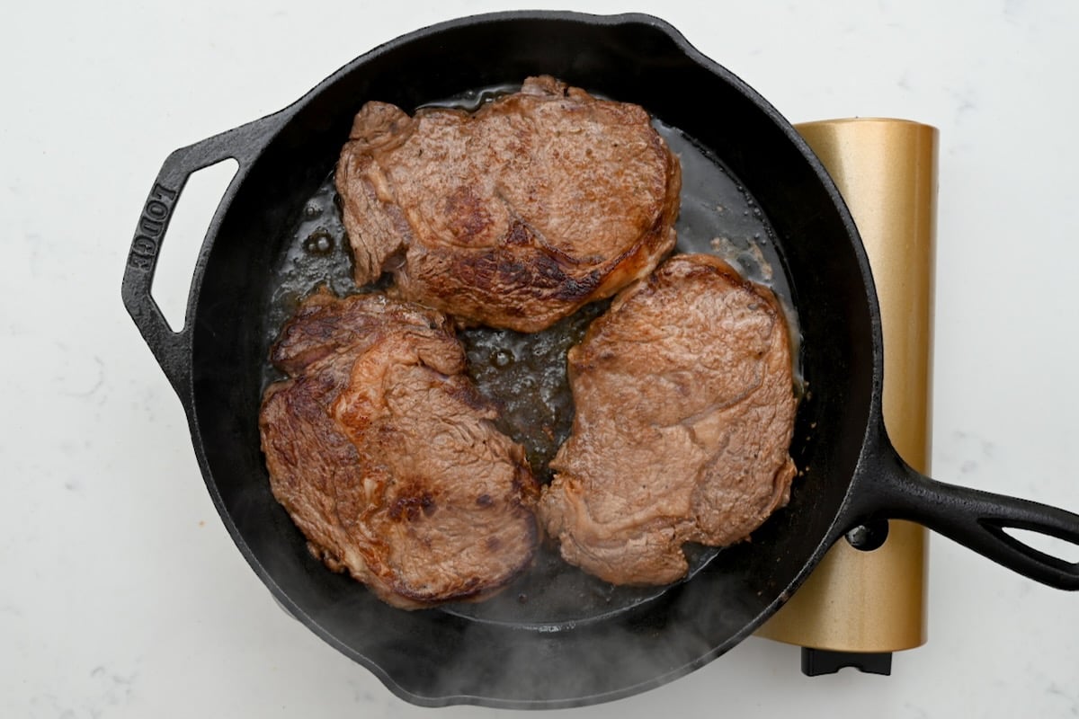 top view of cooked steak on cast iron skillet