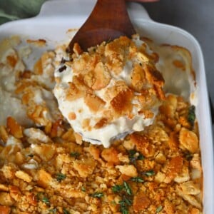 Chicken casserole with a large spoonful scooping it from the dish.