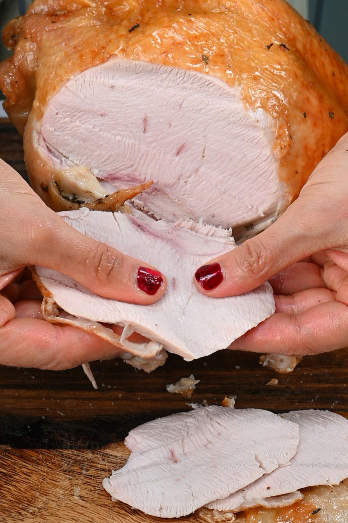 Close-up of juicy turkey slices being held by hand. - 2