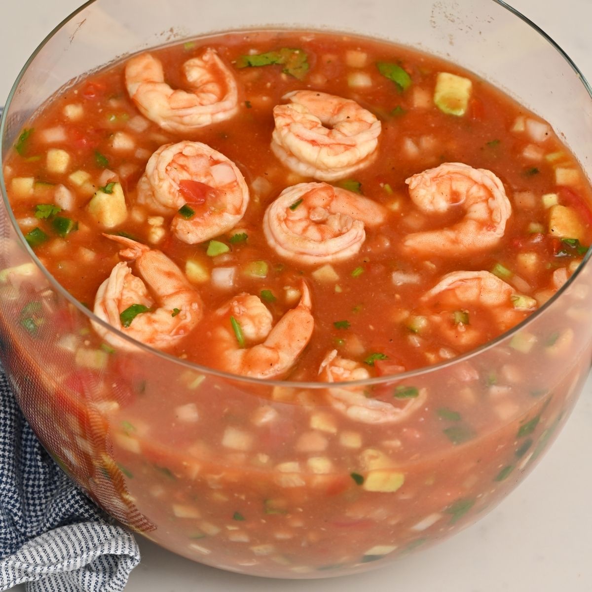 Mexican shrimp cocktail served in a large clear bowl.