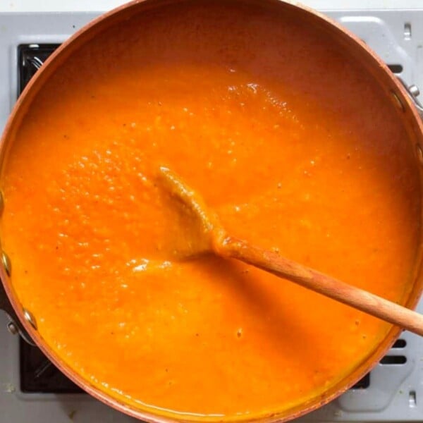 Close-up of pumpkin soup cooking in a pot, perfect cozy winter recipe.