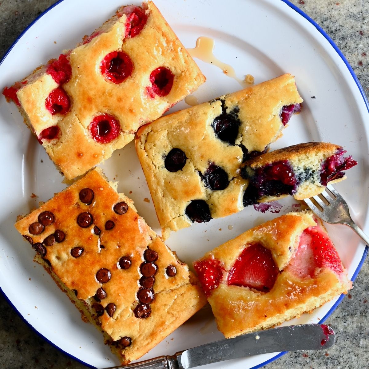 Sliced sheet pan pancakes served on a plate, drizzled with maple syrup - 8