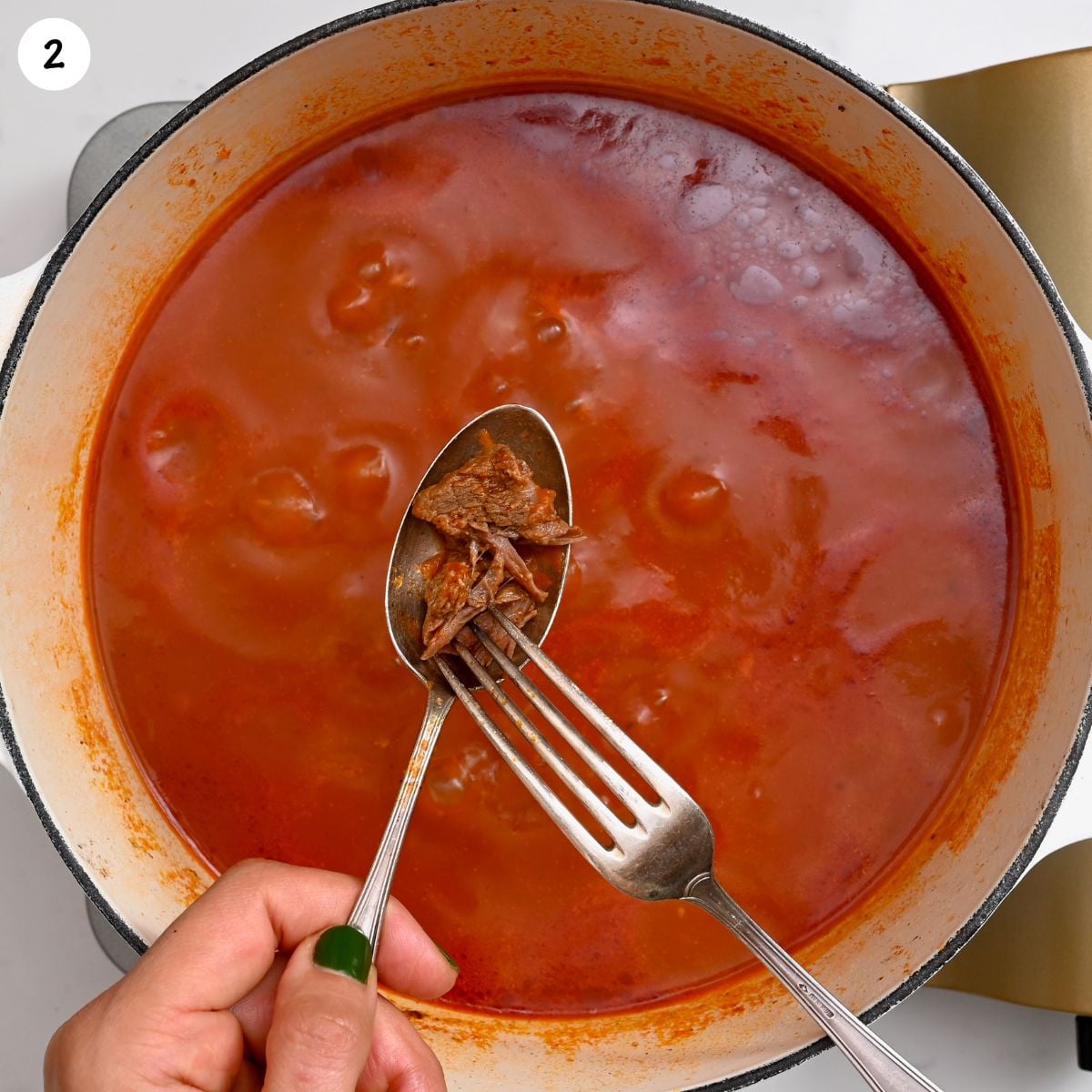 Close-up of the bamya stew base without okra, showing a rich tomato sauce.