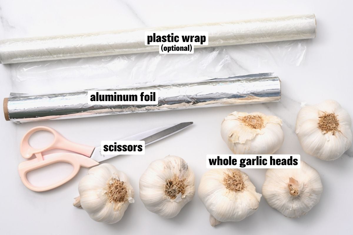 A photo of whole garlic heads and aluminum foil needed to make black garlic.