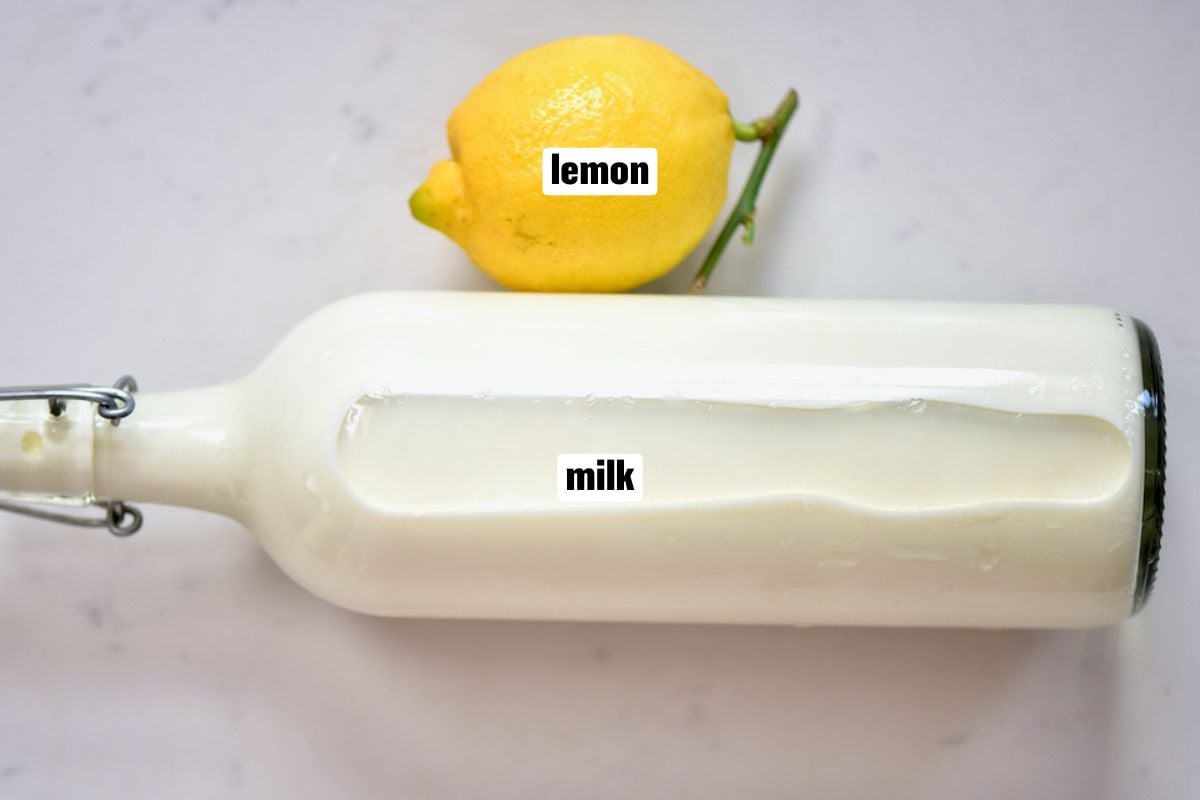 A bottle of milk and a lemon are needed to make cream cheese.