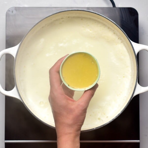 Adding lemon juice to milk.