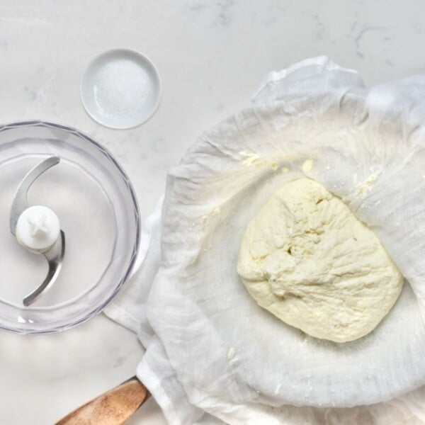 Drained milk curds and salt ready to be blended.
