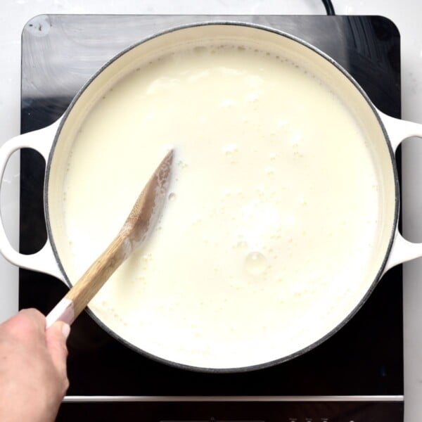 Heating milk in a large pot.