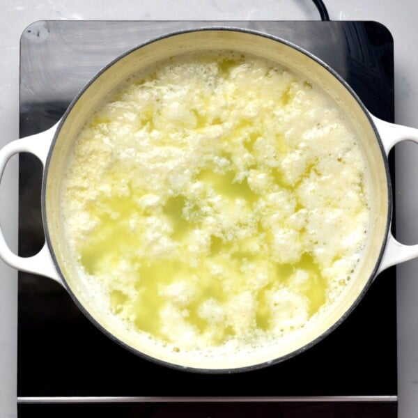 Milk curds formed in a large pot.