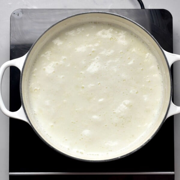 Waiting for curds to form in a large pot.