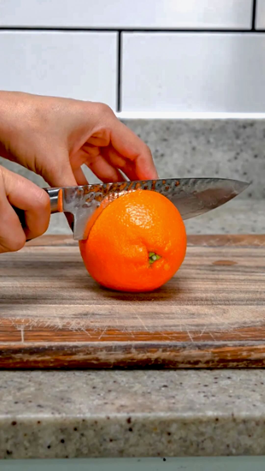 Cutting an orange in half.