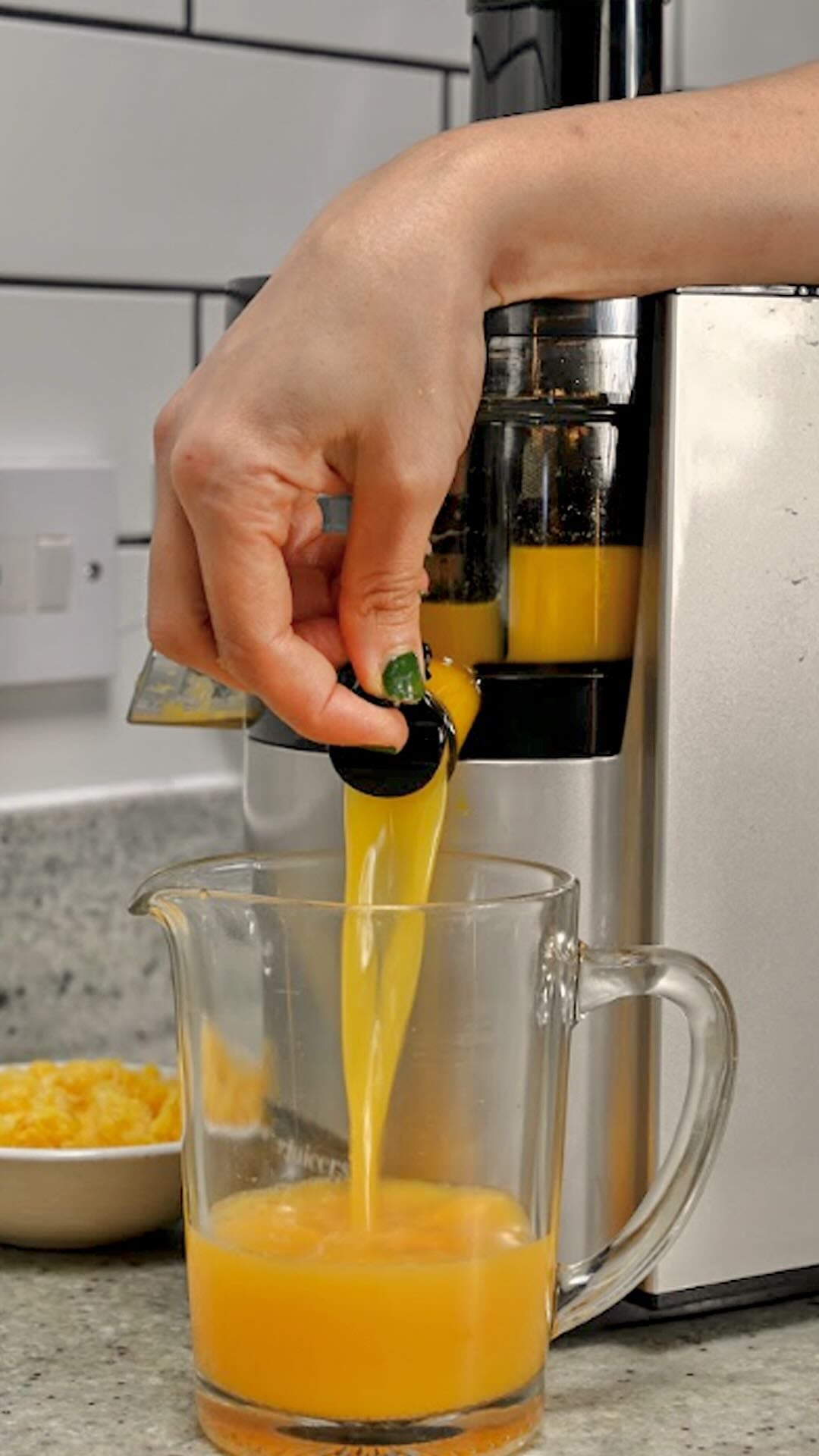 Orange juice in a glass made with a juicer.