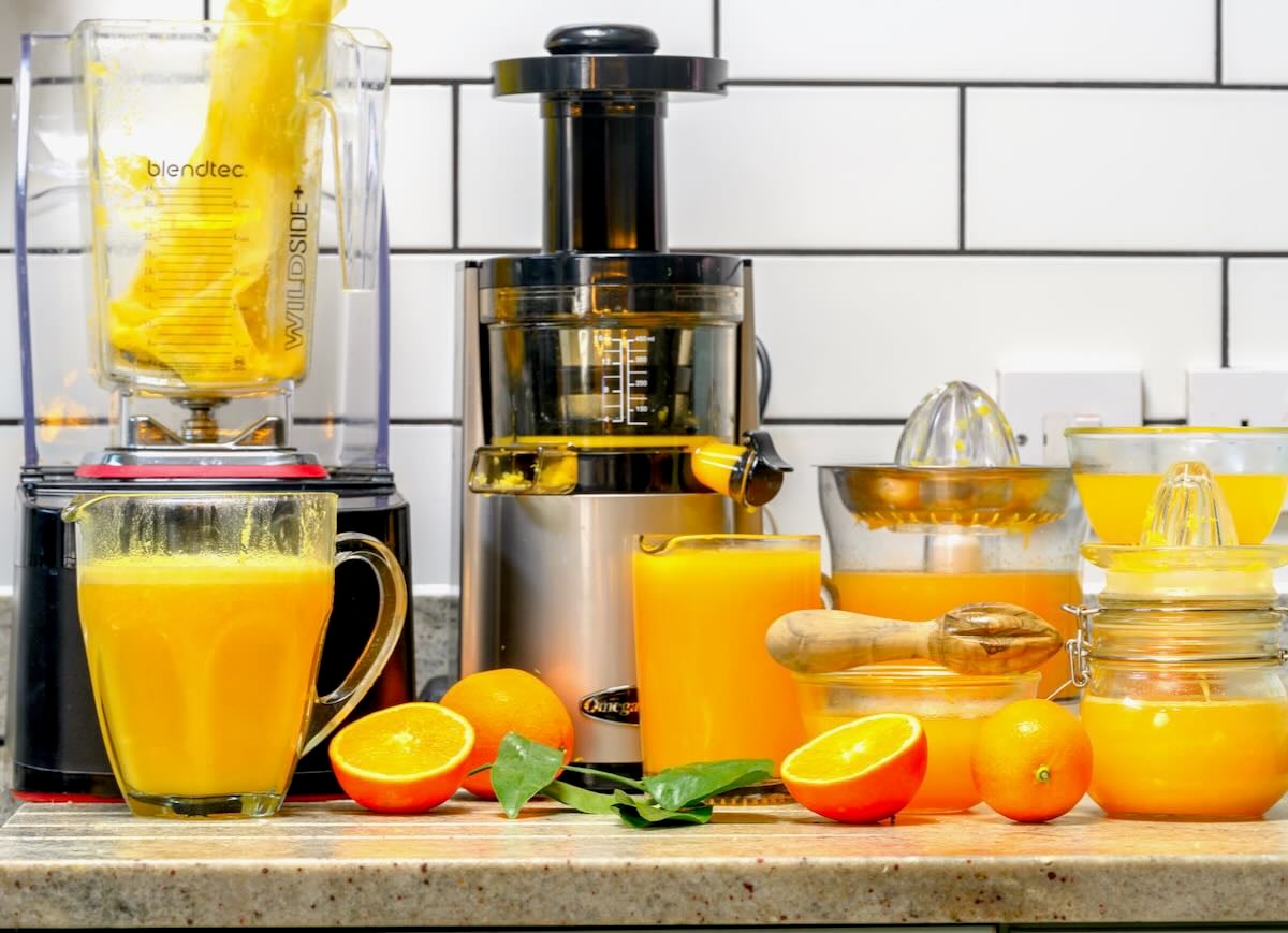 Orange juice made with different tools like a reamer, juicer, blender, and more.