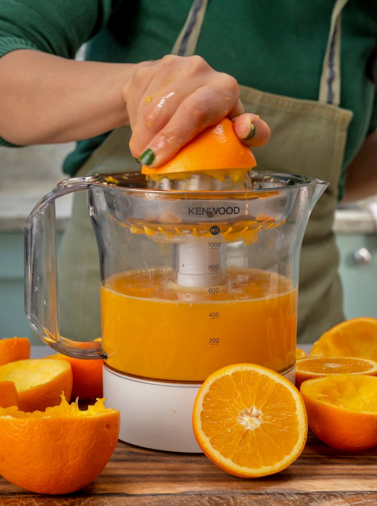 Using an electric juicer to make orange juice.