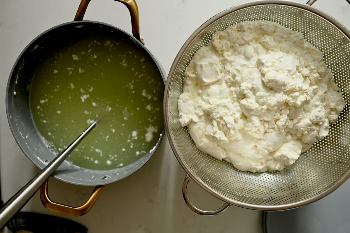 Draining the cheese curds in a bowl.