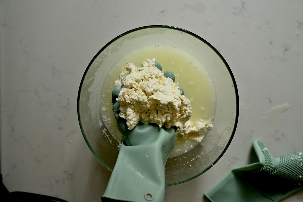 Folding cheese curds to make mozzarella.