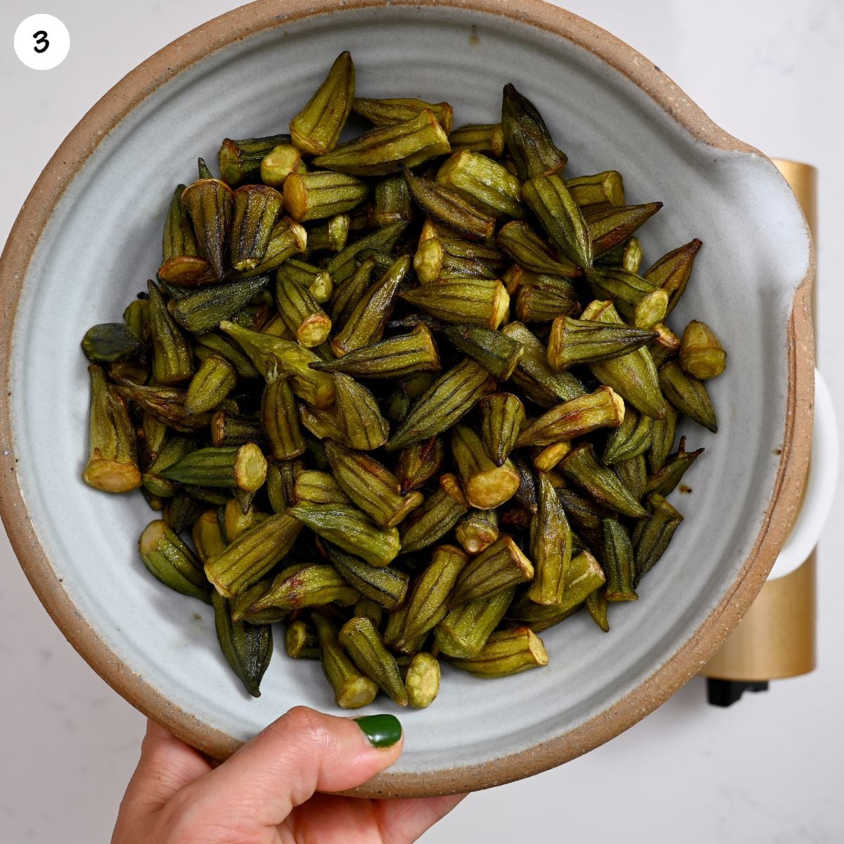 Tender, cooked okra served in a bowl, ready to be added to stew.