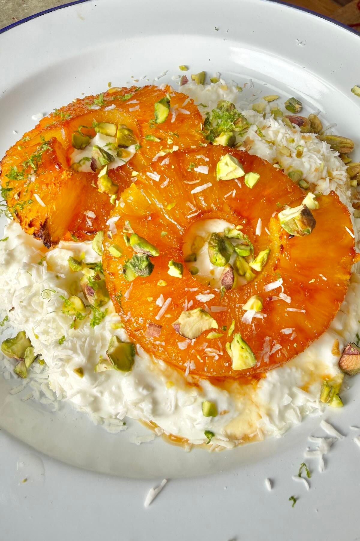 Cottage cheese topped with caramelized pineapple rings, pistachios, coconut flakes, and lime zest.