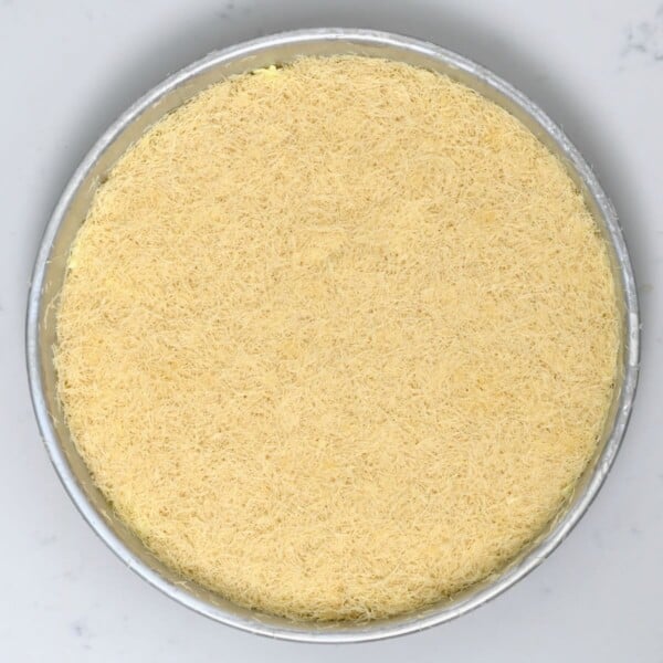 Kunafa in a baking pan ready to bake.