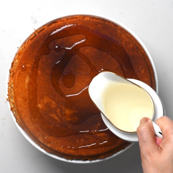 Pouring sugar syrup over freshly baked kunafa.