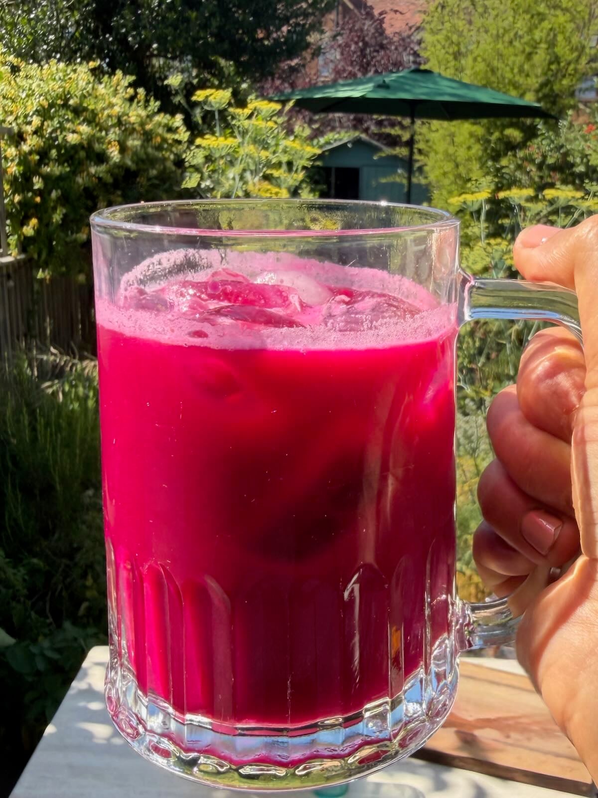 A glass of freshly made ABC juice with a bright ruby color.