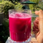 A glass of freshly made ABC juice with a bright ruby color.