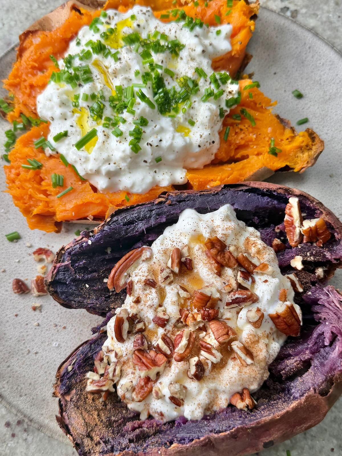 Two sweet potatoes cooked in an air fryer, cut in half, and topped with various toppings.