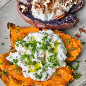 Two sweet potatoes cooked in an air fryer, cut in half, and topped with various toppings.