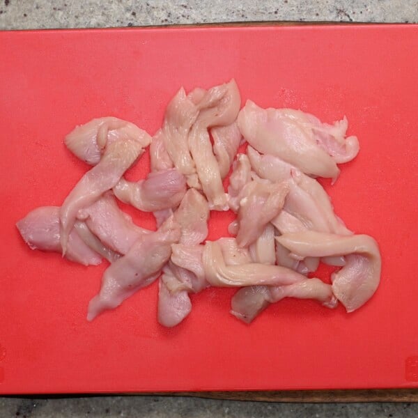 Chicken breasts sliced into strips.