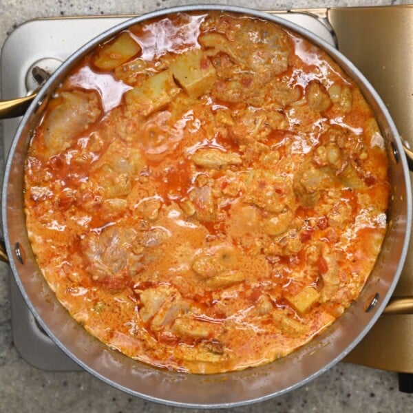 The meat curry for chicken biryani in a large saucepan.