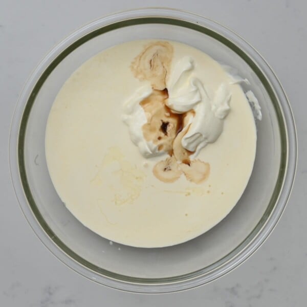 Vanilla extract added to the other ingredients in the bowl.