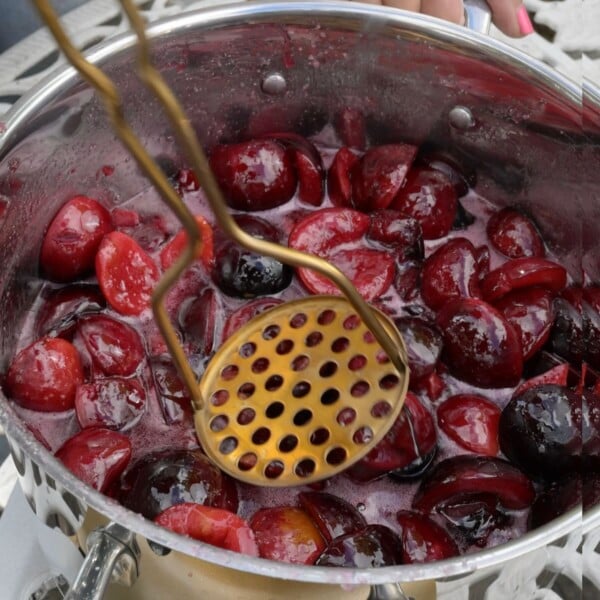 Mashing plums when making jam.