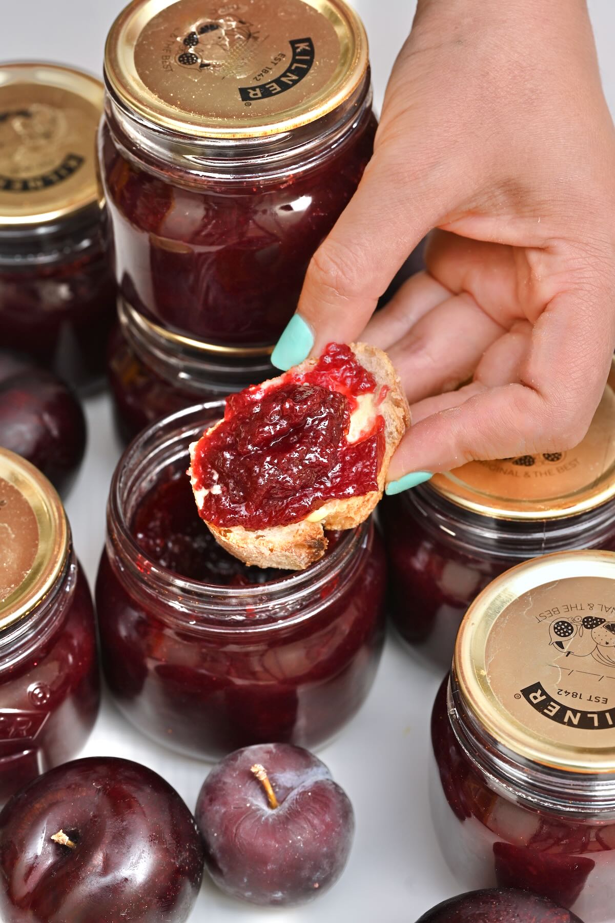 Plum jam spread on a piece of bread.