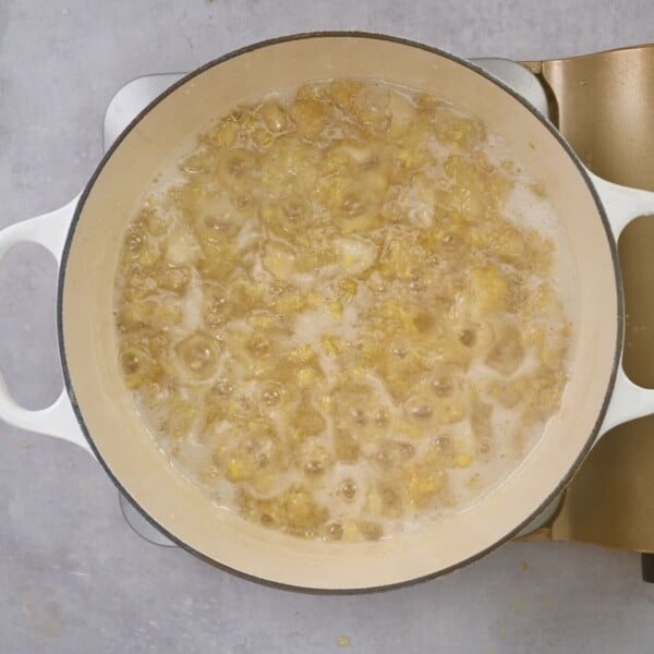 Ginger jam bubling in a large saucepan.