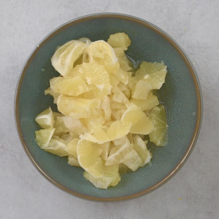 Lemons chopped into small chunks in a bowl.