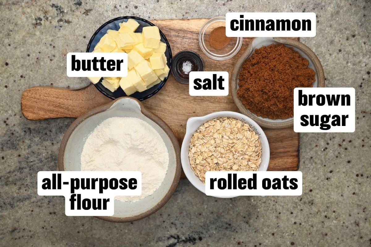 Ingredients flat-lay for crisp topping, including butter, oats, brown sugar, flour, cinnamon, and salt.
