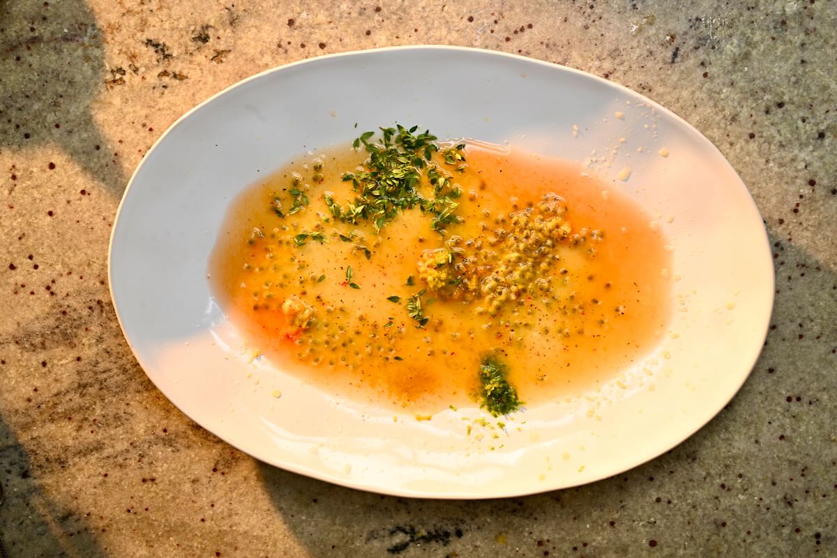 Dressing ingredients added to a large plate.